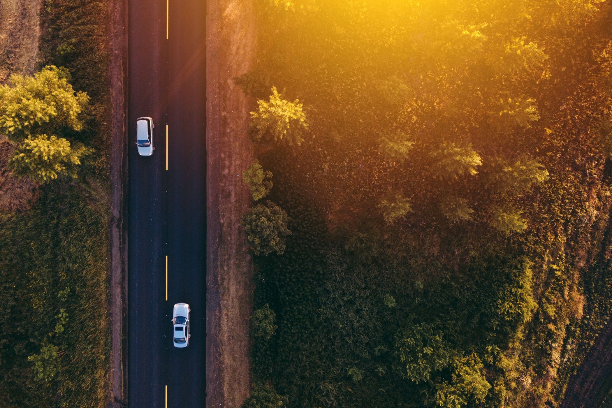 aerial-view-of-cars-on-the-road-in-sunset-P68URWZ.jpg
